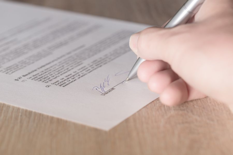 Person signing contract for real estate photography